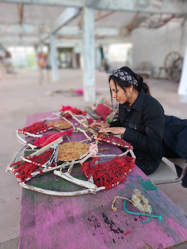 Woking with red discarded textiles and silk